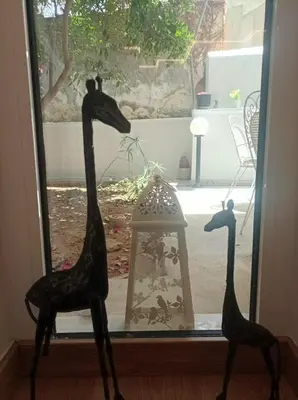two giraffes standing next to a window at Modern familiar house under Acropolis in Athens