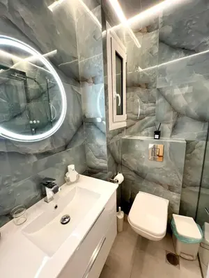 a bathroom with a white sink and a toilet at Modern familiar house under Acropolis in Athens
