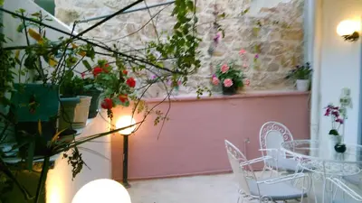 a patio with a table and chairs and flowers at Modern familiar house under Acropolis in Athens