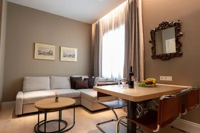 a living room with a couch and a table at Syntagma Zairas Hideaway! in Athens