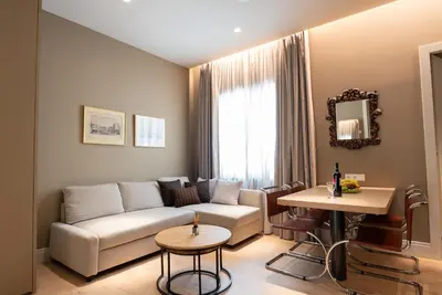 a living room with a couch and a table at Syntagma Zairas Hideaway! in Athens