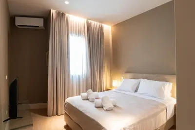 a bedroom with a bed with towels on it at Syntagma Zairas Hideaway! in Athens