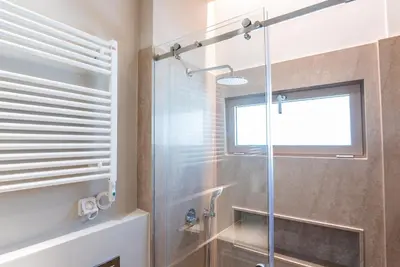 a bathroom with a shower with a glass door at Syntagma Zairas Hideaway! in Athens
