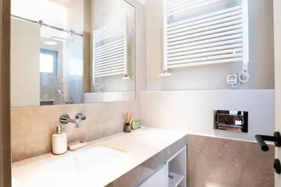 a bathroom with two sinks and a mirror at Syntagma Zairas Hideaway! in Athens