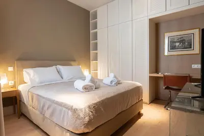 a bedroom with a bed with towels on it at Syntagma Zairas Hideaway! in Athens