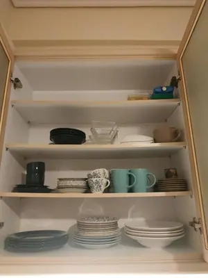 a cabinet filled with plates and cups and dishes at 2room-flat, perfect kitchen in Athens, Pangkrati 100Μbits in Athens