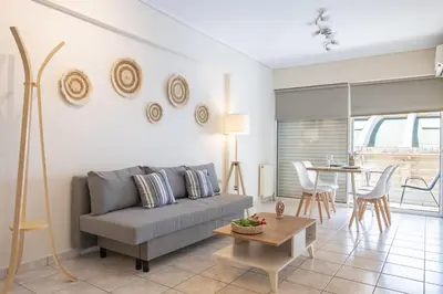 a living room with a couch and a table at Welcome apartment in Athens