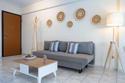 a living room with a couch and a table at Welcome apartment in Athens