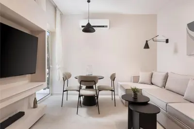 a living room with a couch and a table at Glyfada Prime Living in Athens