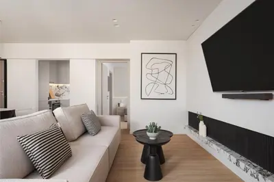 a living room with a couch and a flat screen tv at Glyfada Prime Living in Athens