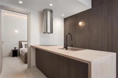 a kitchen with a sink and a bedroom at Glyfada Prime Living in Athens