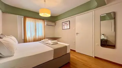 a bedroom with a bed with towels on it at Beach house in the heart of Athens Riviera in Athens