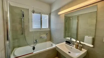 a bathroom with a tub and a sink and a shower at Beach house in the heart of Athens Riviera in Athens