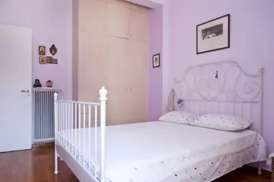 a white bed in a room with a white crib at Athens Panormou station in Athens