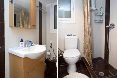 a bathroom with a toilet and a sink and a shower at Athens Panormou station in Athens