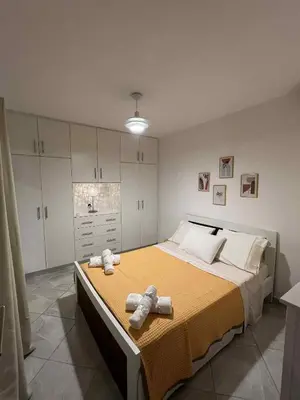a bedroom with a large bed with towels on it at Minimal Above in Paianía
