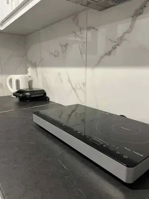 a laptop sitting on a counter in a room at Minimal Above in Paianía