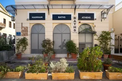 a building with potted plants in front of it at The Saints Inn in Athens