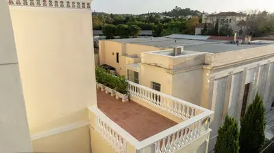 a balcony with a view of a building at The Saints Inn in Athens