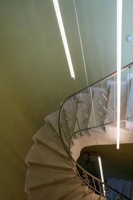 a spiral staircase with ties hanging from a ceiling at The Saints Inn in Athens