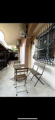 a group of tables and chairs in a building at Modern Glyfada Apartment Sleeps 6, 5min Walk to Beach in Athens