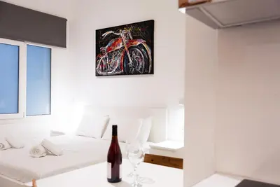 a room with white furniture and a painting on the wall at Syntagma square 25sqm Cozy studio in Athens