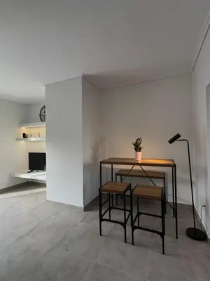 a dining room with a table and a lamp at Captain's flat in Piraeus