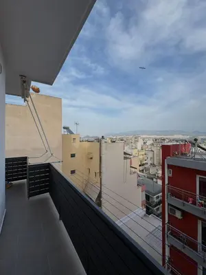 a balcony with a view of a city at Captain's flat in Piraeus
