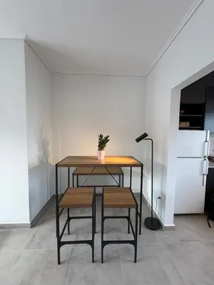 a table with a potted plant on it in a room at Captain's flat in Piraeus