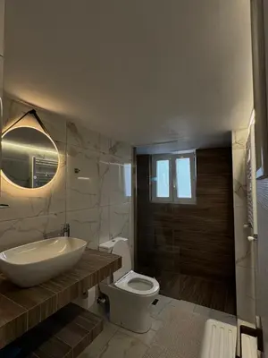 a bathroom with a sink and a toilet and a tub at Captain's flat in Piraeus