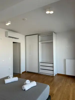 a bedroom with a bed and a walk in closet at Niarchos Elegant Penthouse in Athens