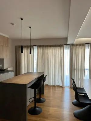 a kitchen with a table and chairs in a room at Niarchos Elegant Penthouse in Athens