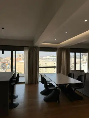 a conference room with a table and chairs and a large window at Niarchos Elegant Penthouse in Athens