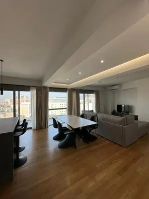 a living room with a table and a couch at Niarchos Elegant Penthouse in Athens