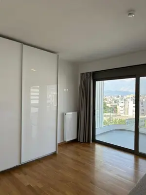 an empty living room with a large sliding glass door at Niarchos Elegant Penthouse in Athens
