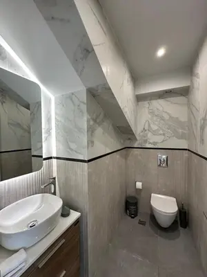 a bathroom with a sink and a toilet at Niarchos Elegant Penthouse in Athens