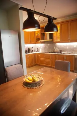 a kitchen with a table with a bowl of fruit on it at Maisonette Chalandri by DV10 Family House Luxury Oasis in Athens