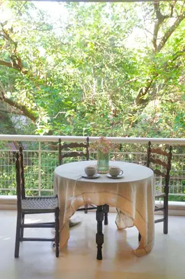 a table with two cups and a vase on a porch at Maisonette Chalandri by DV10 Family House Luxury Oasis in Athens