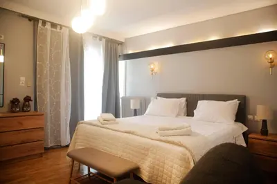 a bedroom with a large bed with white sheets at Maisonette Chalandri by DV10 Family House Luxury Oasis in Athens