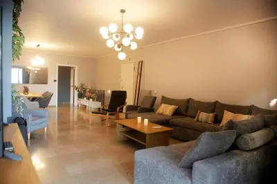 a living room with a couch and a table at Maisonette Chalandri by DV10 Family House Luxury Oasis in Athens