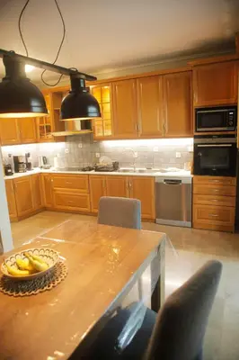a kitchen with a table with a bowl of bananas on it at Maisonette Chalandri by DV10 Family House Luxury Oasis in Athens