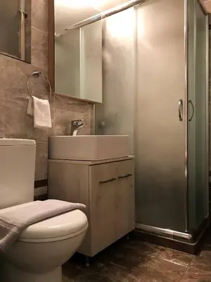 a bathroom with a toilet and a sink and a shower at Acropolis Cozy Apartment in Athens