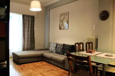 a living room with a couch and a table at Acropolis Cozy Apartment in Athens