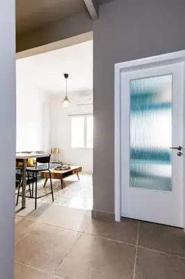 a white door in a room with a table at Acropolis Lane in Athens