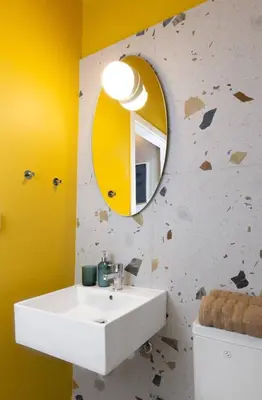 a bathroom with a white sink and a yellow mirror at Acropolis Lane in Athens