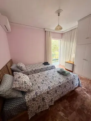 a bedroom with a bed and a window at Avra Deluxe Apartment in Athens