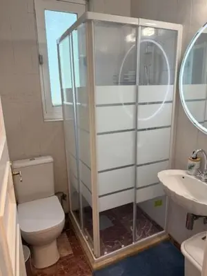 a bathroom with a shower and a toilet and a sink at Avra Deluxe Apartment in Athens