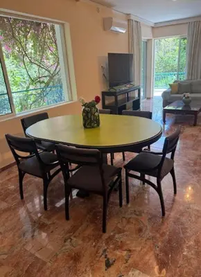 a table and chairs in a living room with a table at Avra Deluxe Apartment in Athens