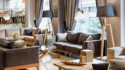 a living room with leather couches and a table at Acropolis Select in Athens