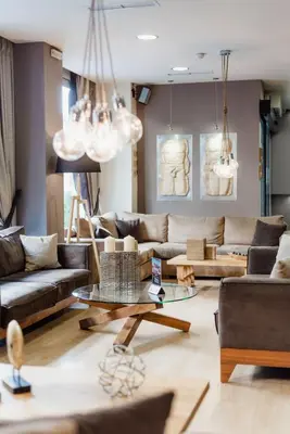 a living room with couches and tables and chandeliers at Acropolis Select in Athens